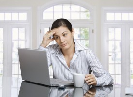 business woman thinking problem laptop coffee