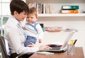 woman working from home with baby on laptop