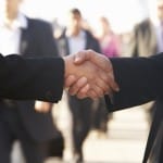 business woman man shaking hands outside