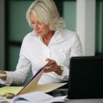 senior business woman looking at files