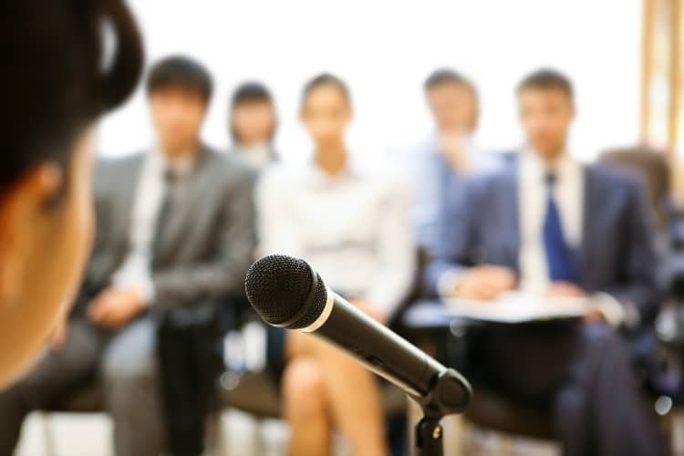 business woman speech speaking microphone audience