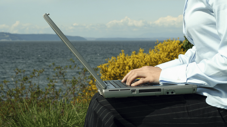 woman laptop beach