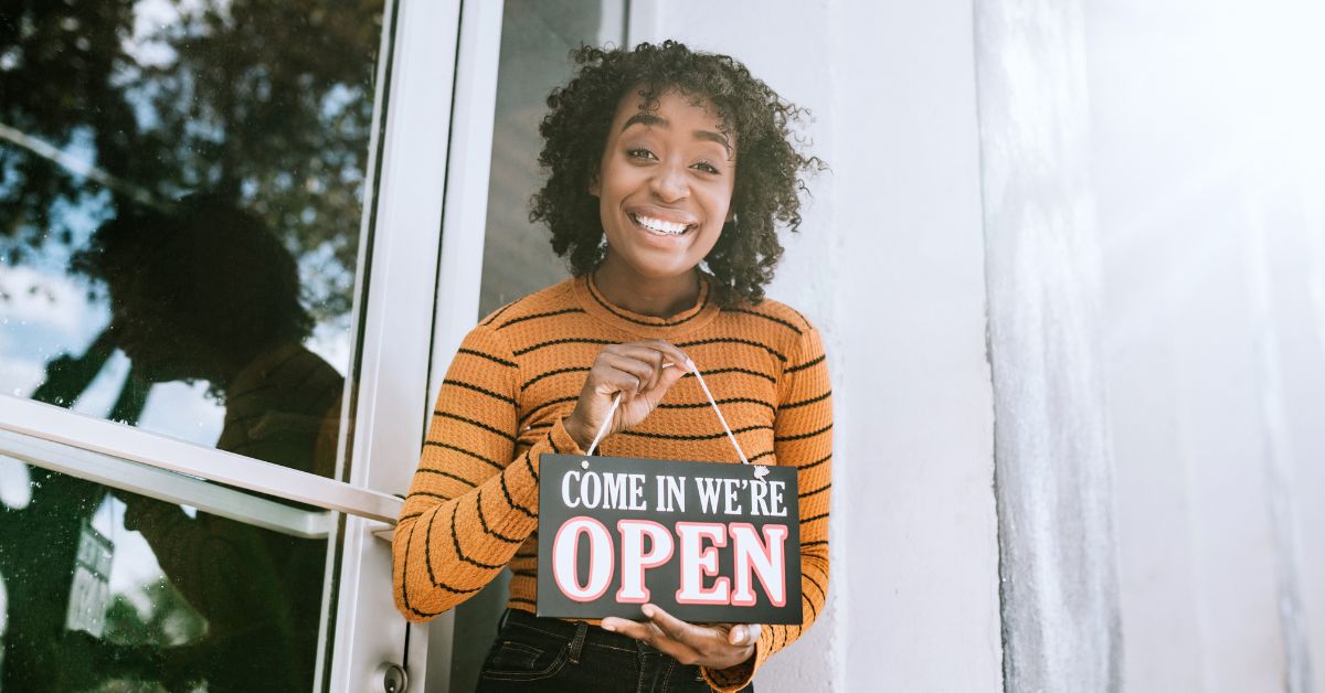 woman business owner entrepreneur open sign