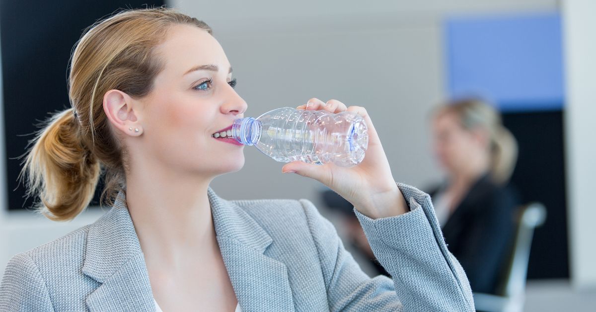 businesswoman drinking water