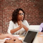 Professional women demonstrating leadership and management skills during a team discussion