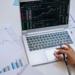 woman with laptop looking at stock graph