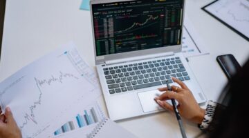 woman with laptop looking at stock graph