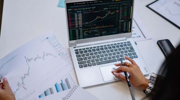 woman with laptop looking at stock graph