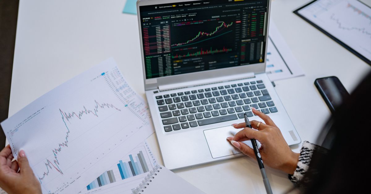 woman with laptop looking at stock graph