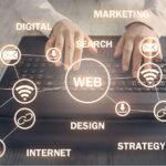 keyboard hands typing with web development and marketing icons