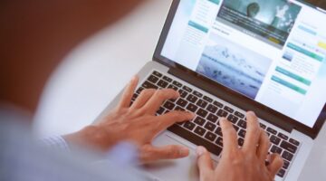 writing website content on laptop keyboard