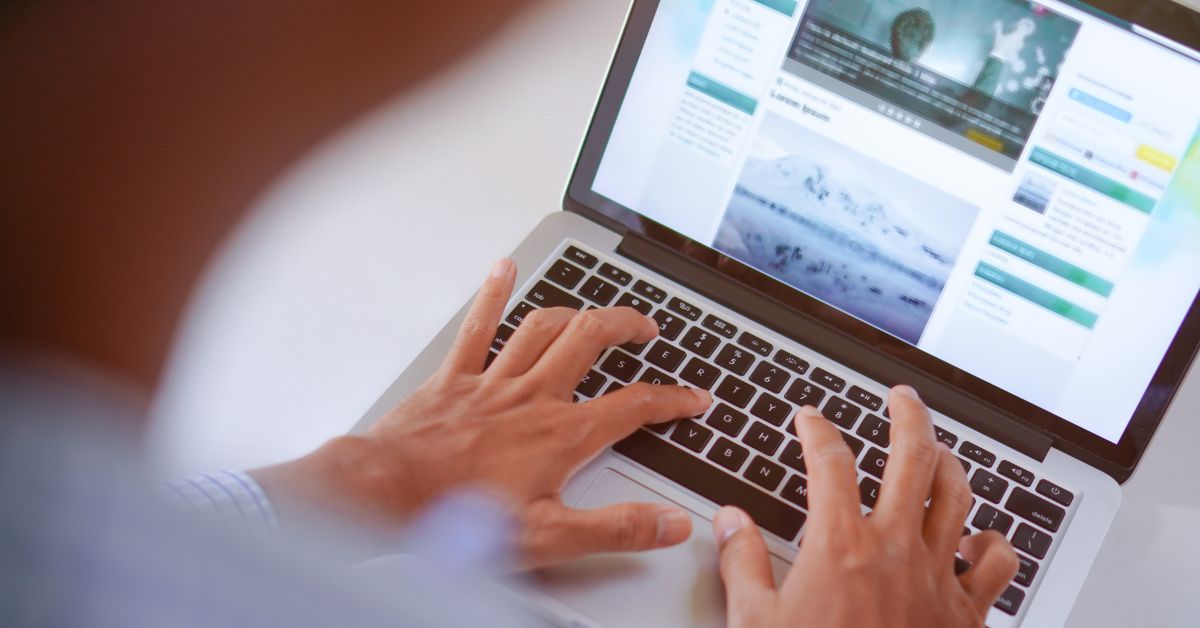 writing website content on laptop keyboard