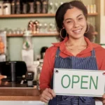 woman business owner cafe open sign