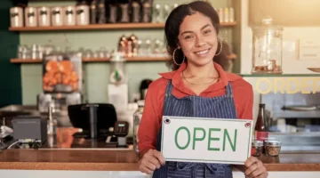 woman business owner cafe open sign