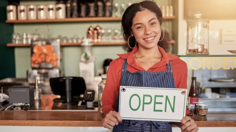 woman business owner cafe open sign