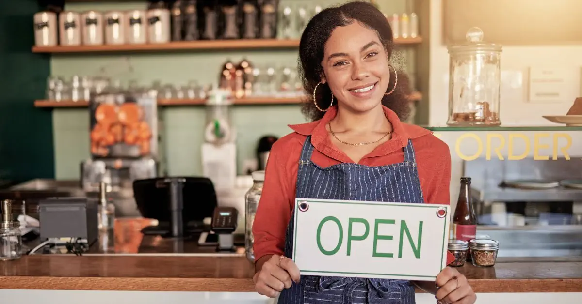 woman business owner cafe open sign