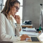 woman business owner of fashion company using laptop