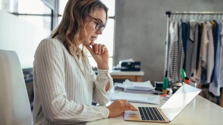woman business owner of fashion company using laptop