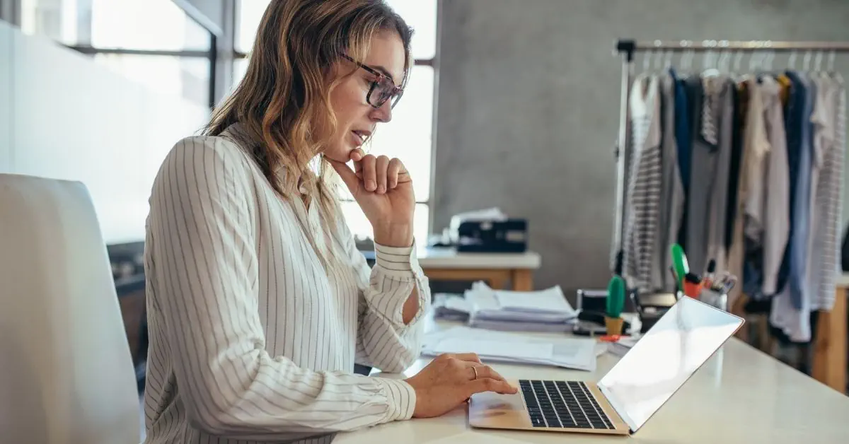 woman business owner of fashion company using laptop